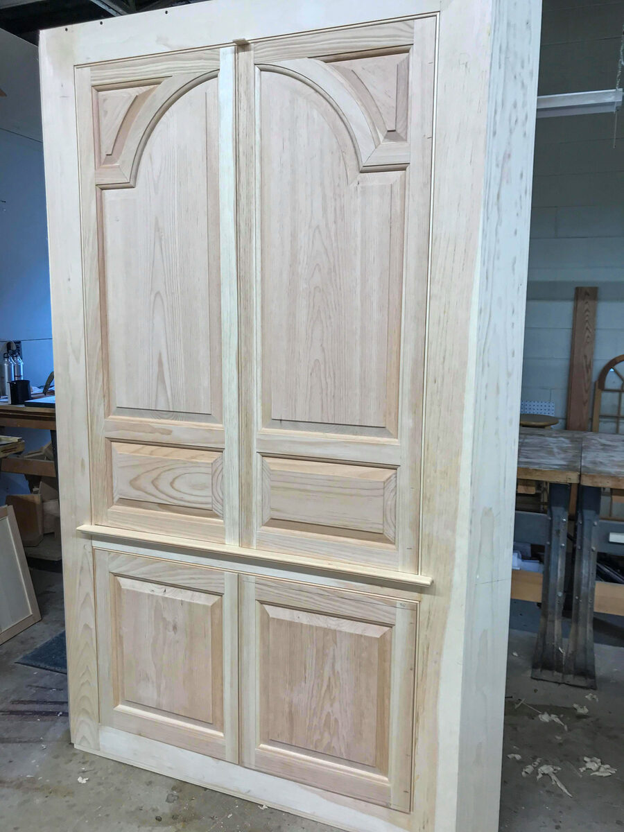 18th-century reproduction corner cupboard with glazed arched upper door, raised panel construction