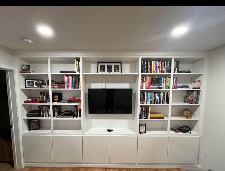 Built-in bookshelves with center TV niche, styled with books and personal items