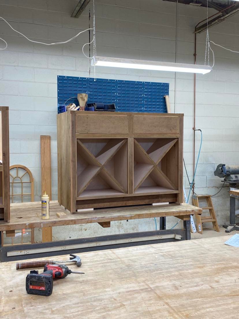 Stacked cabinet carcasses awaiting assembly