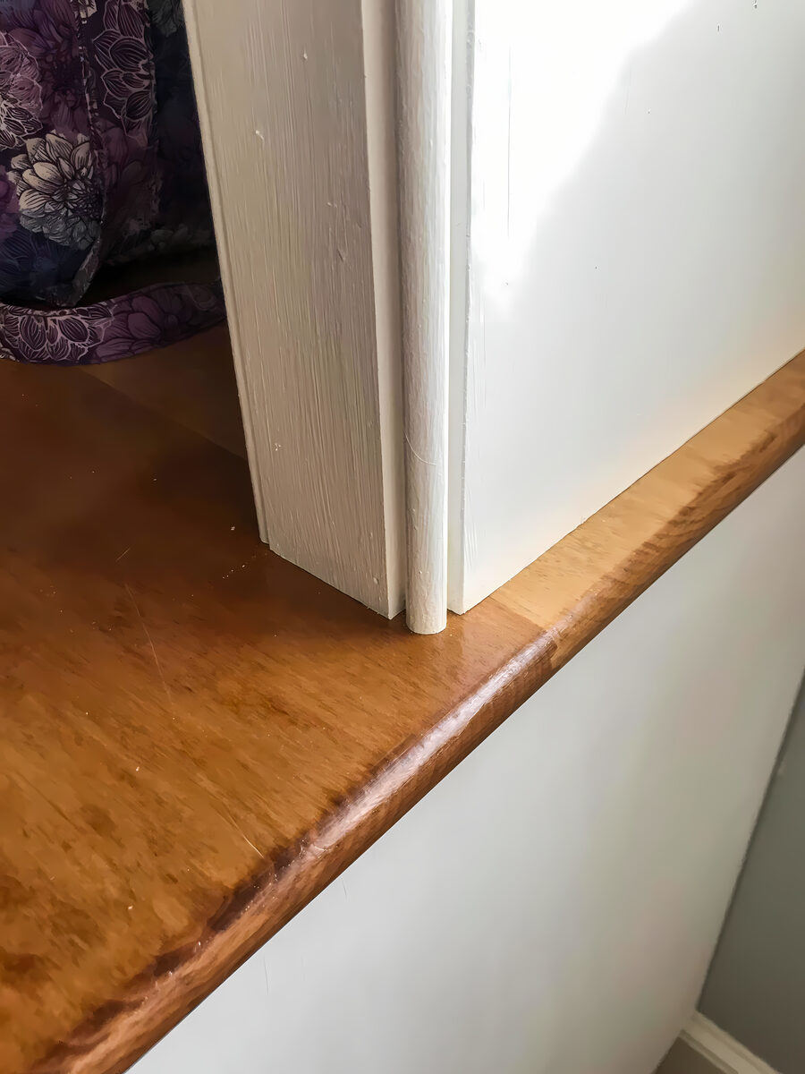 Detailed white painted crown moulding assembly showing dentil course and cove profiles