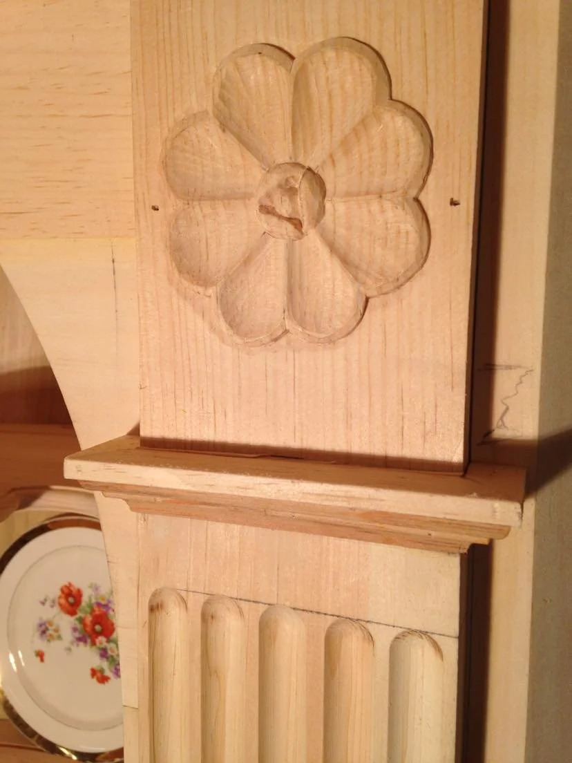 Hand-carved flower and rosette panel, raw pine, close-up detail