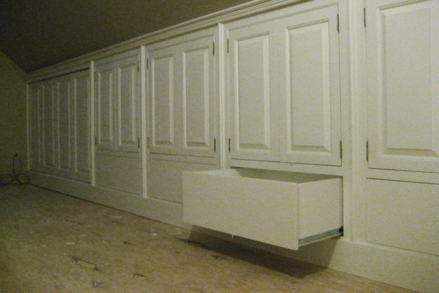 Wall cupboards painted sage green, room view from angle