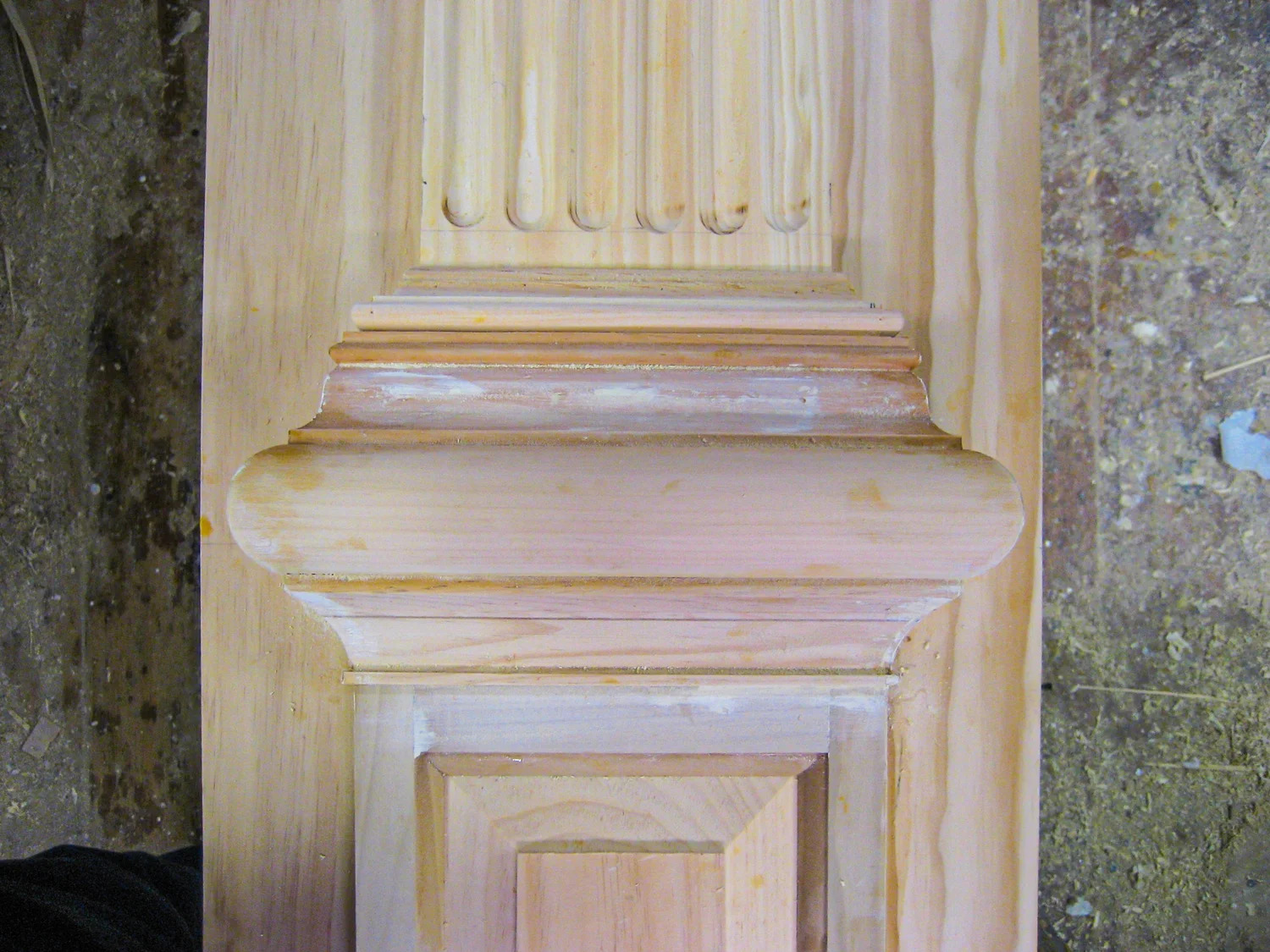 Arched surround painted pale blue-green with applied moulding detail