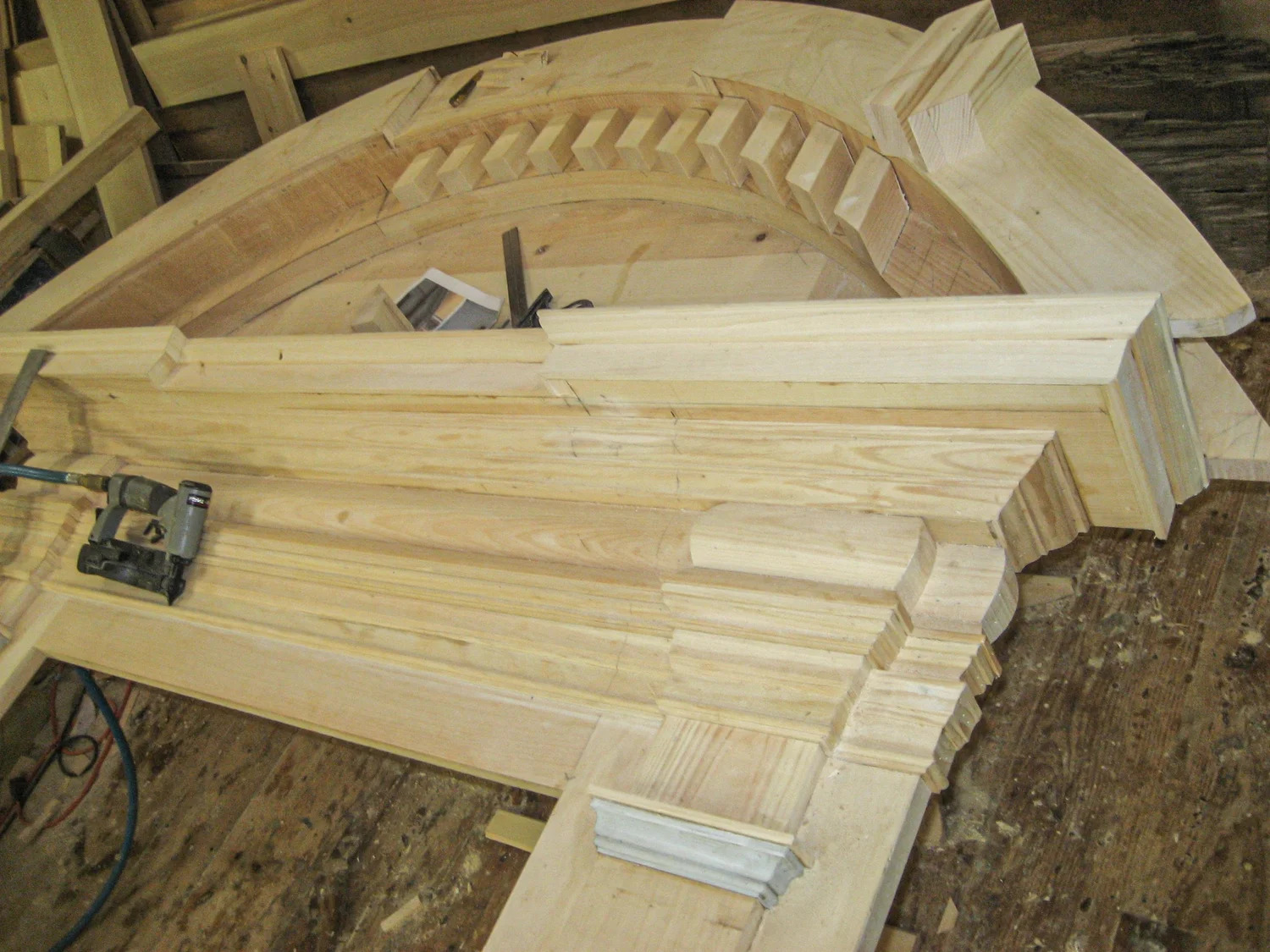 Curved keystone and arch members in raw wood, view from below