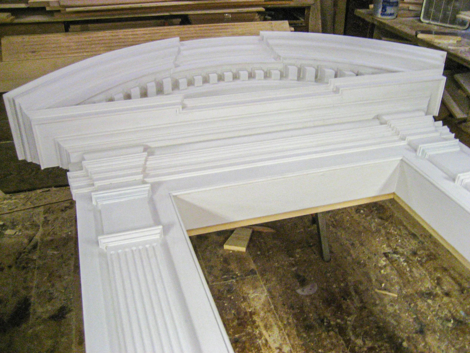 Completed arch cornice profile overhead view, raw wood