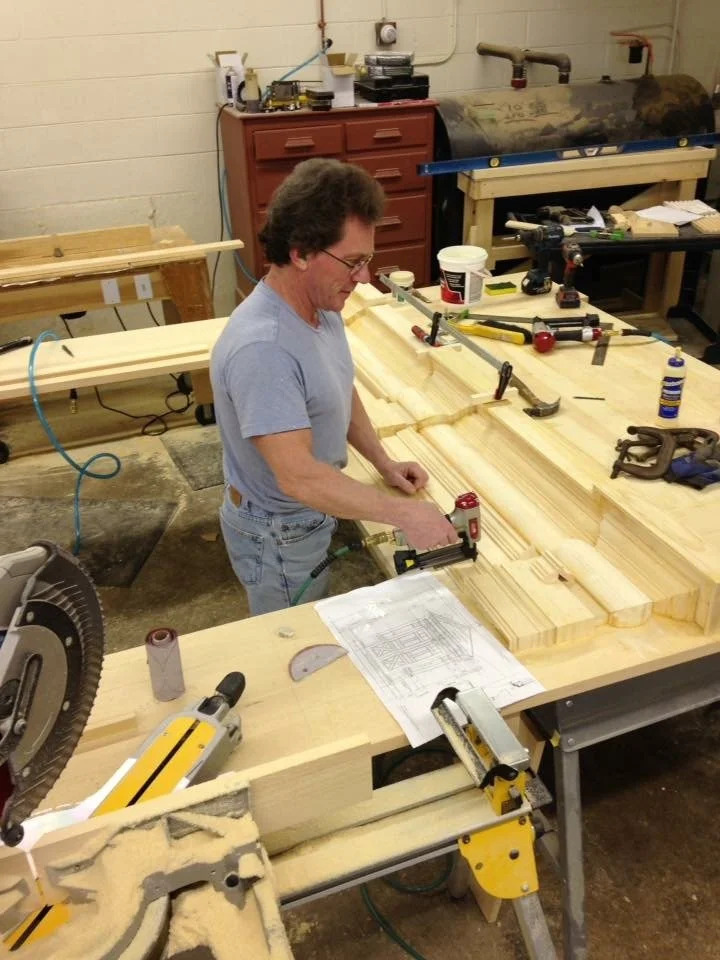 Michael Britten working on pediment components in the shop