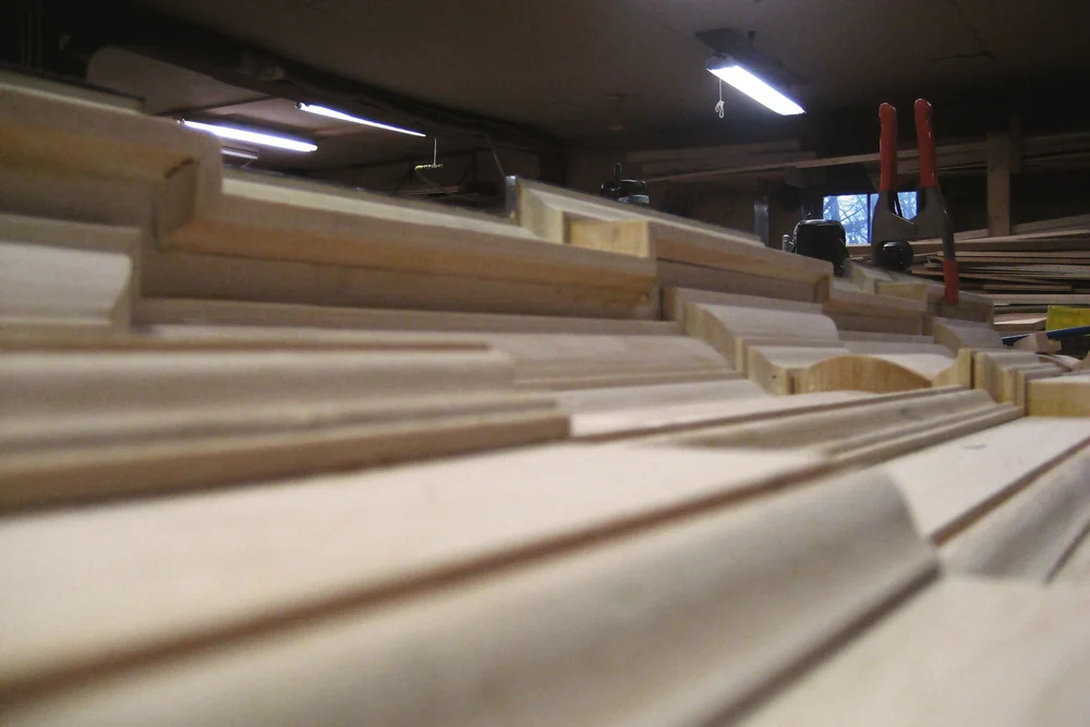 Pilasters and entablature assembly laid out on shop floor