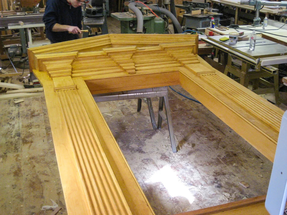 Full door frame assembly laid out on shop floor, wide view