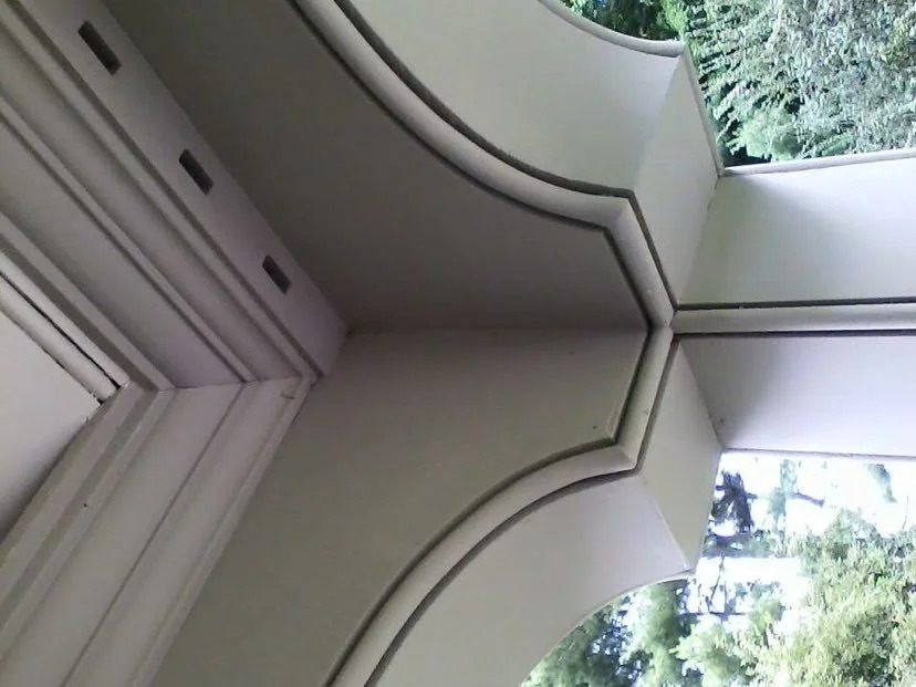 Installed exterior cornice with dentil course, painted white, building exterior