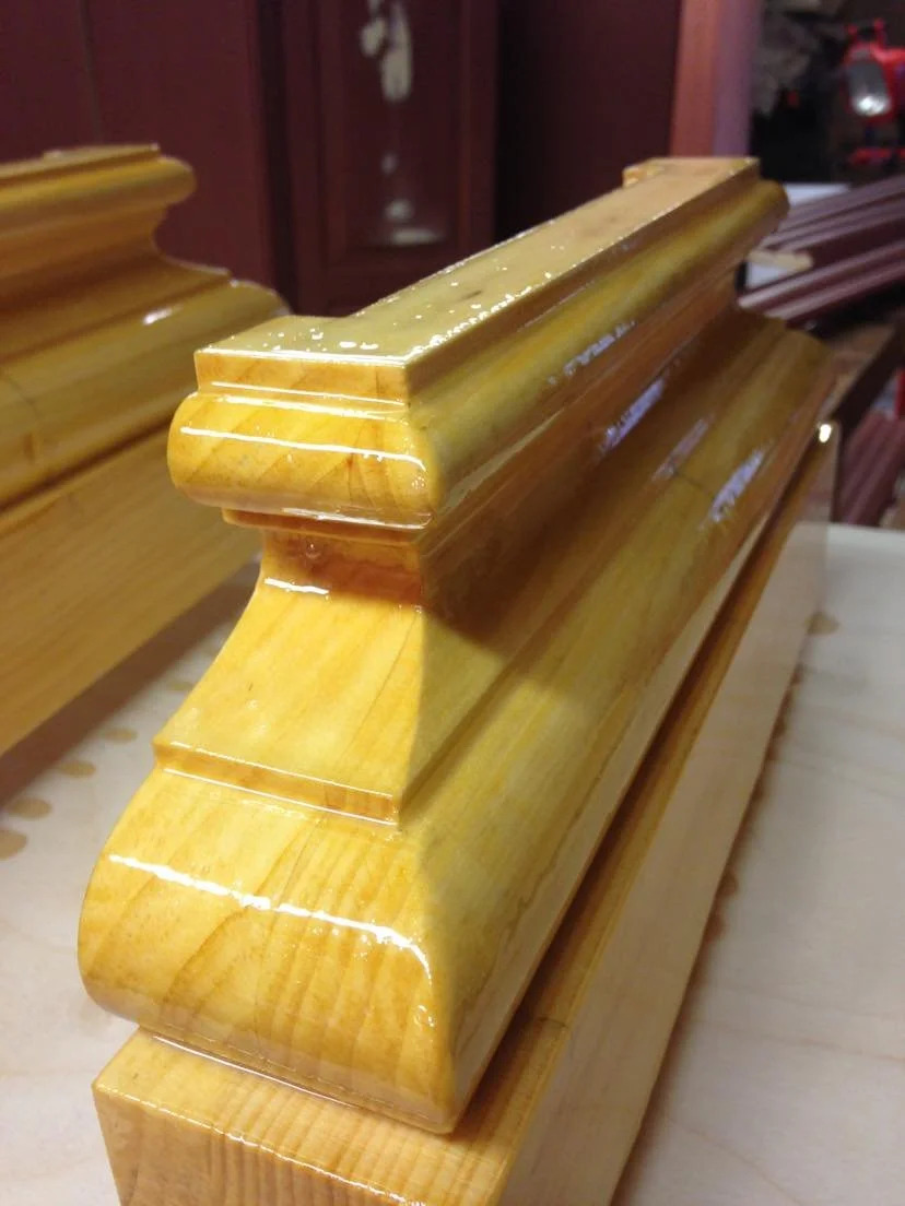 Raw pine entablature showing dentil band and modillion block detail