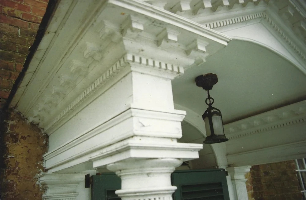 Painted pilaster with fluting and base, aged green-grey finish, mantel detail