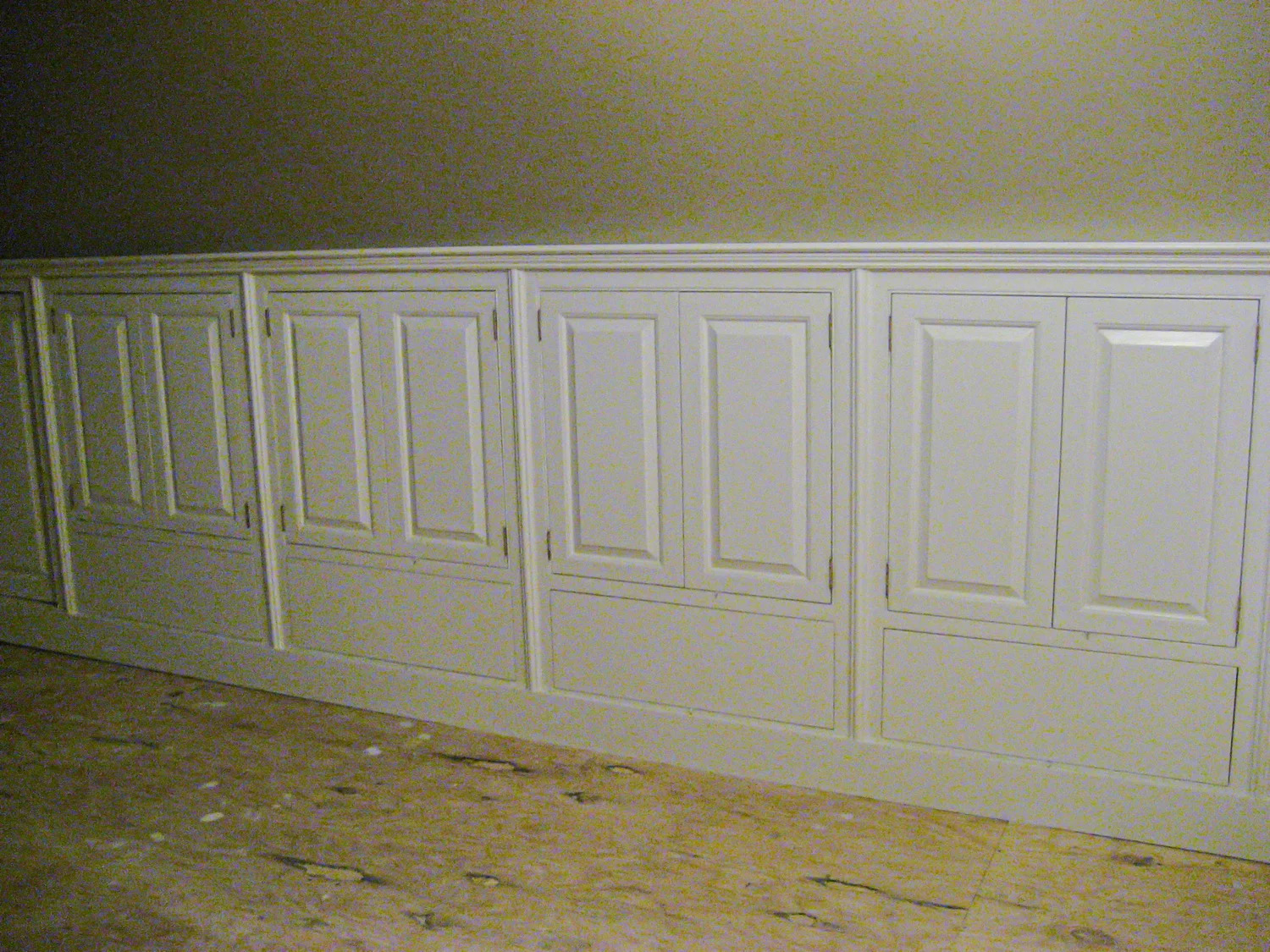 White knee-wall panels installed, closer view showing raised panel detail