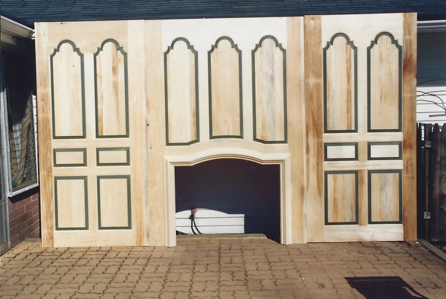 Full-height arched window paneling in dark wood, period interior