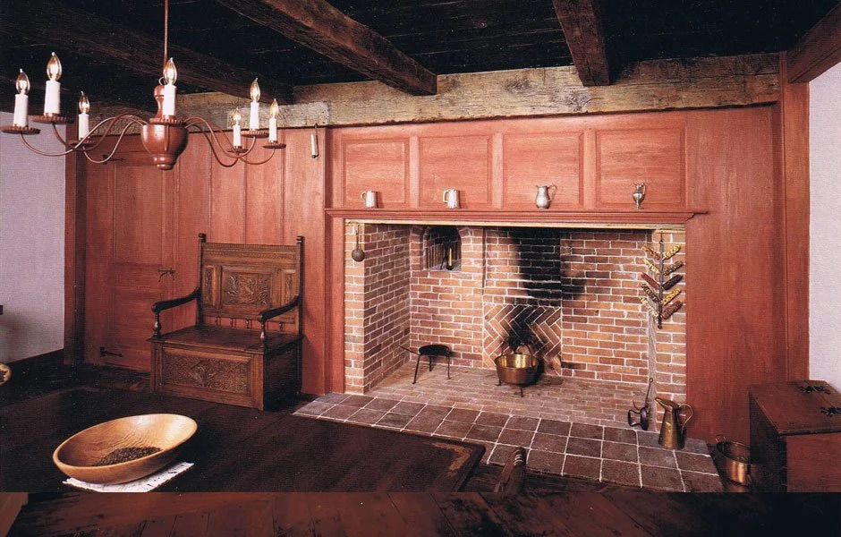 Grey painted wainscot paneling in period room with fireplace surround