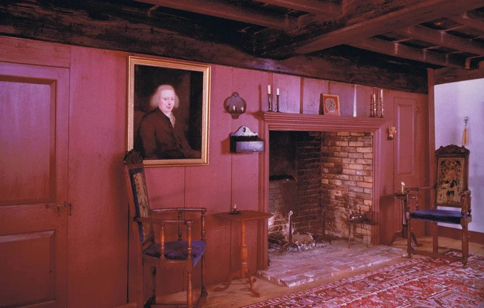 White cream formal room with paneling, fireplace, and period furniture