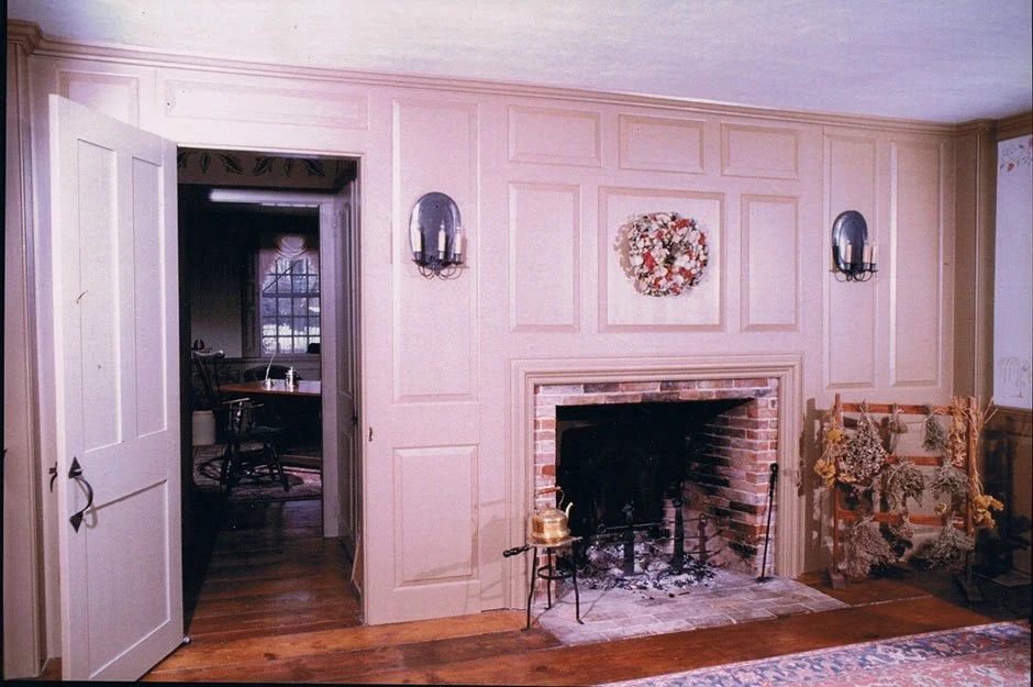 Blue-grey wainscot paneling with applied mouldings and fireplace