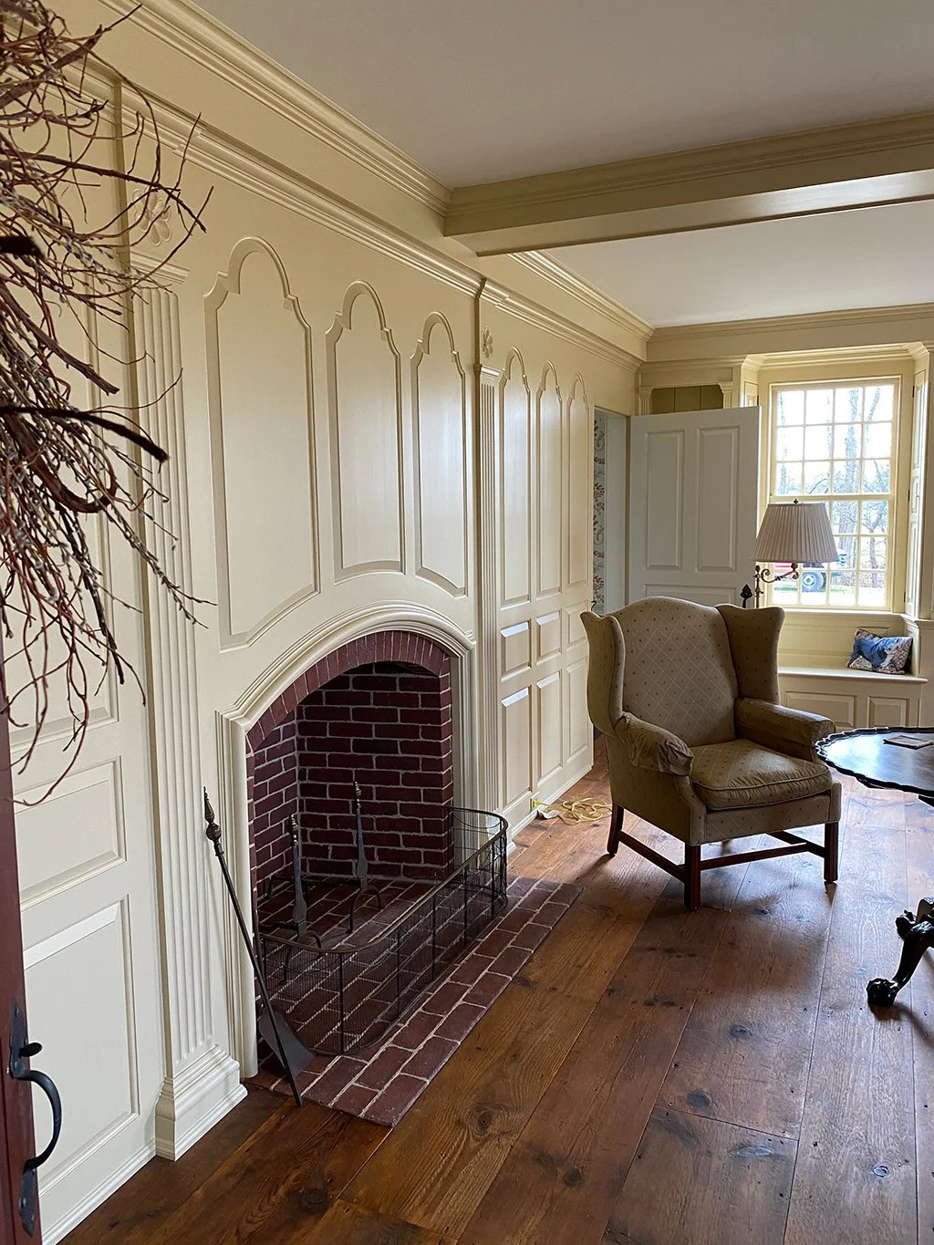 Arched raised-panel chimney breast surround with ornamental woodwork