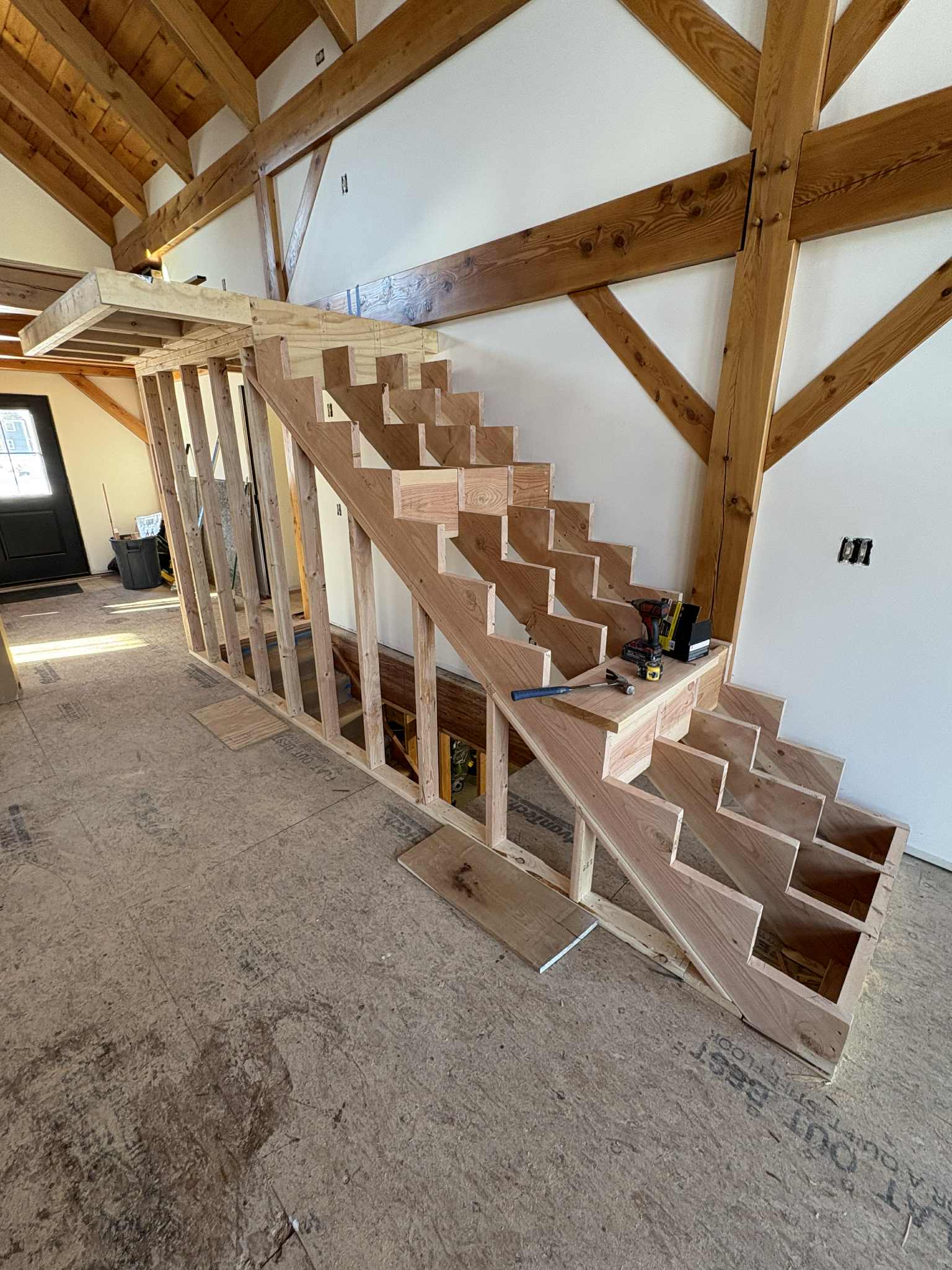 Stair from landing during construction, natural pine framing