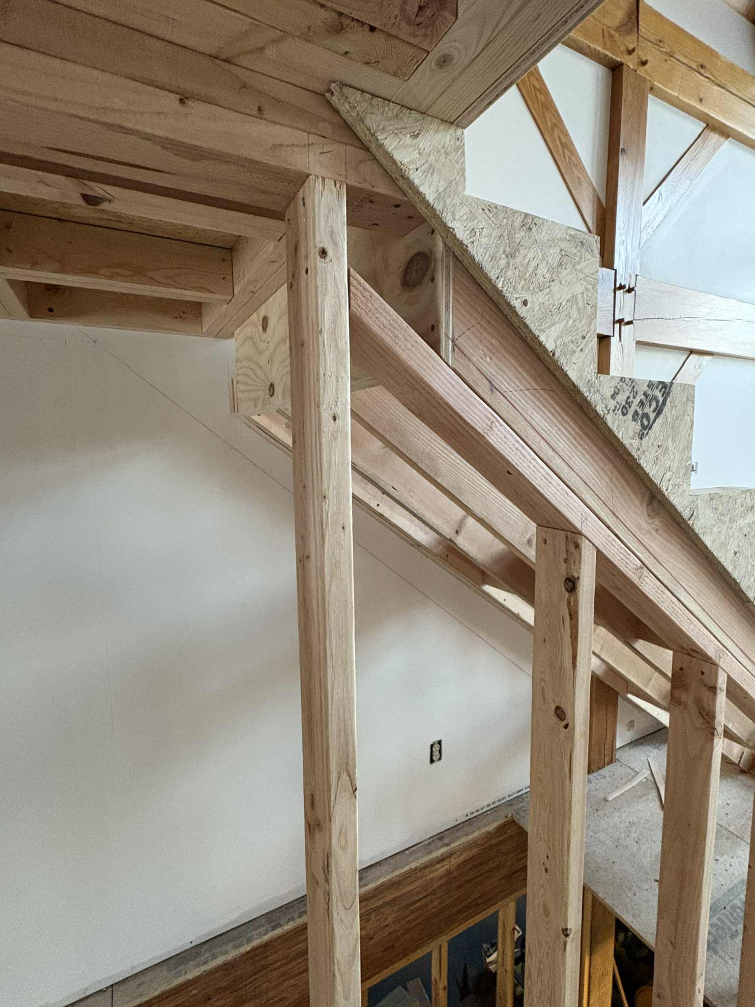 Newel post and baluster connection in natural light, finished installation