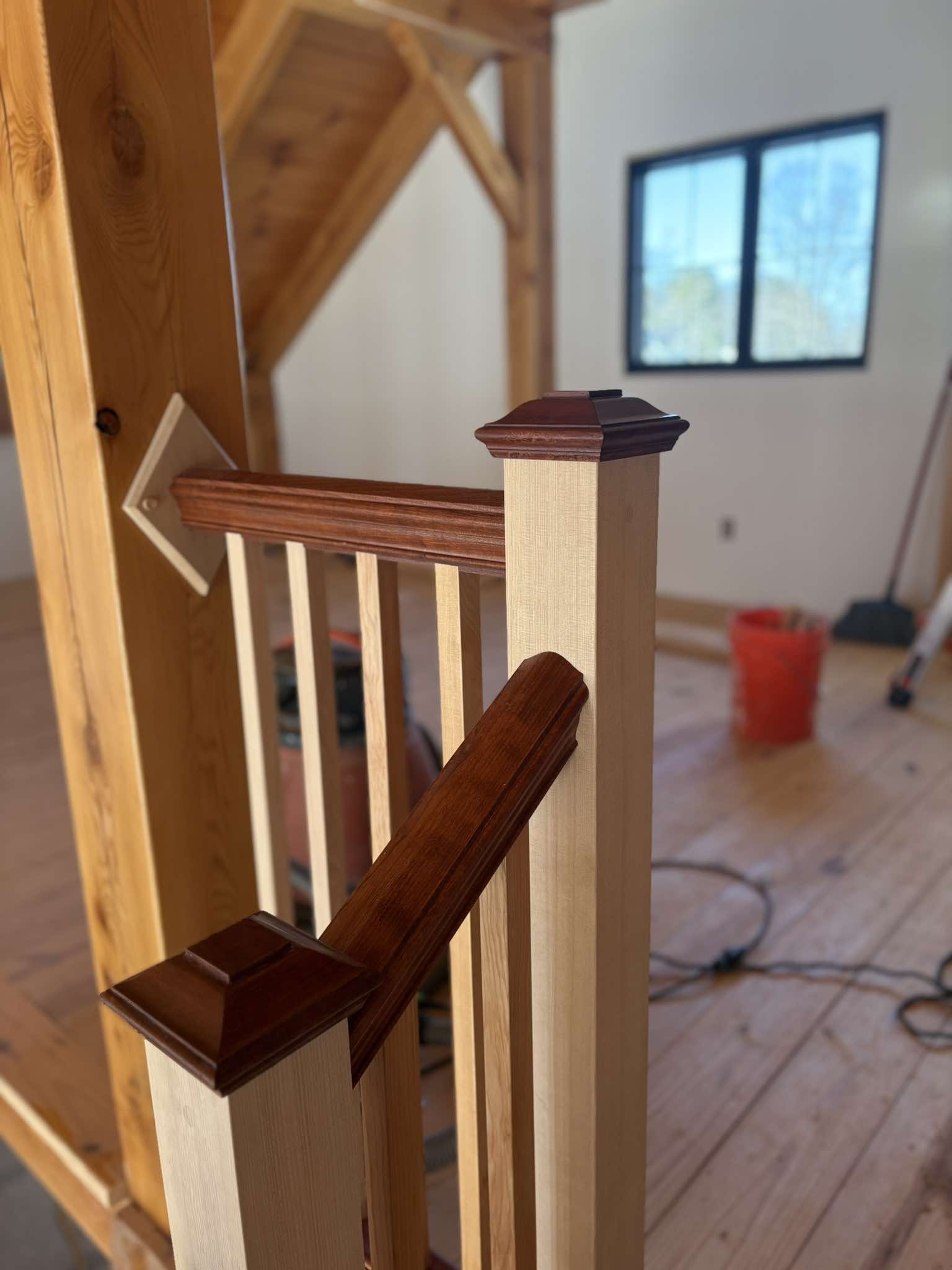Finished newel post with decorative cap, dark stained wood