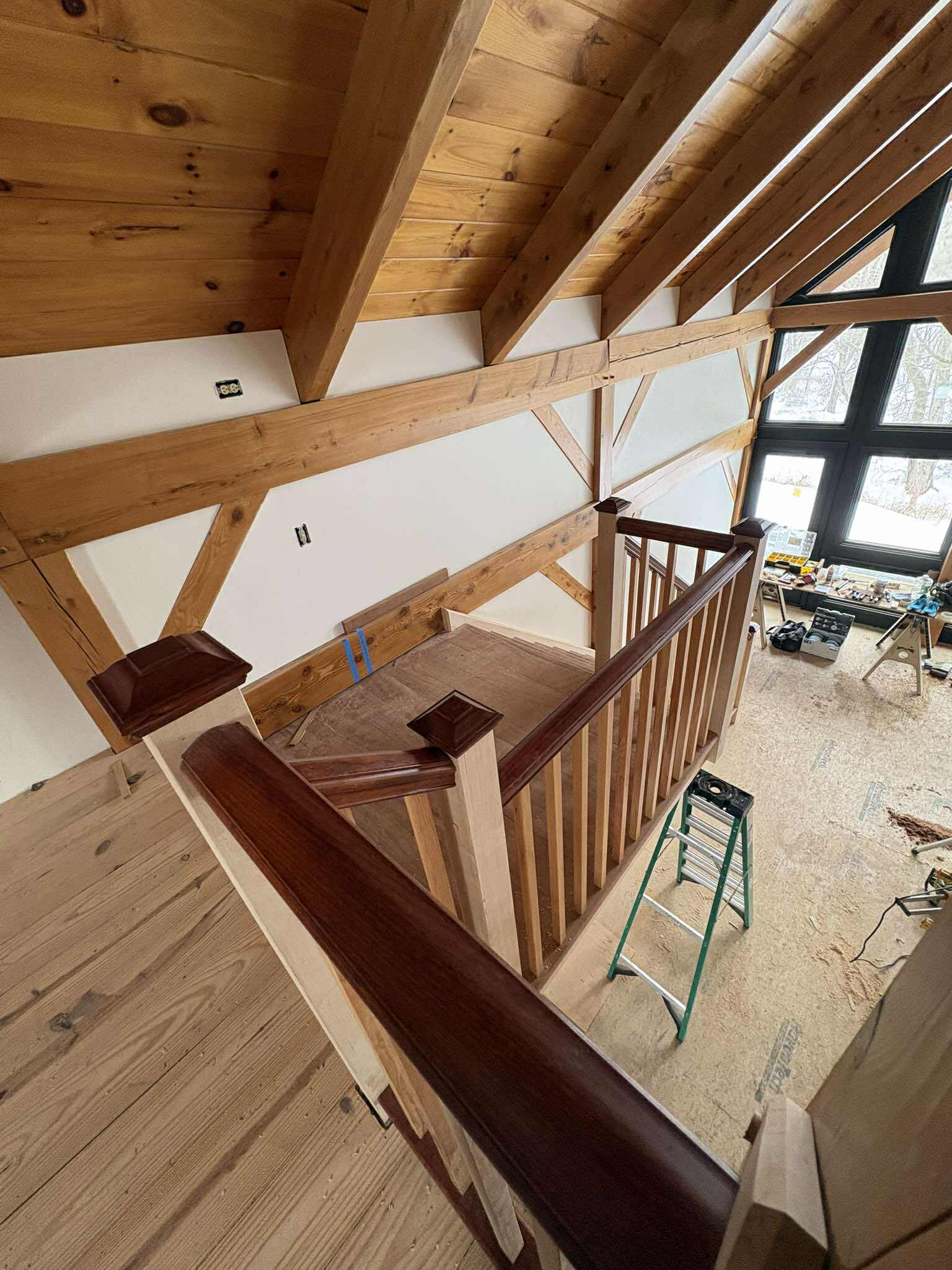 Stair railing run viewed from above, finished dark stain