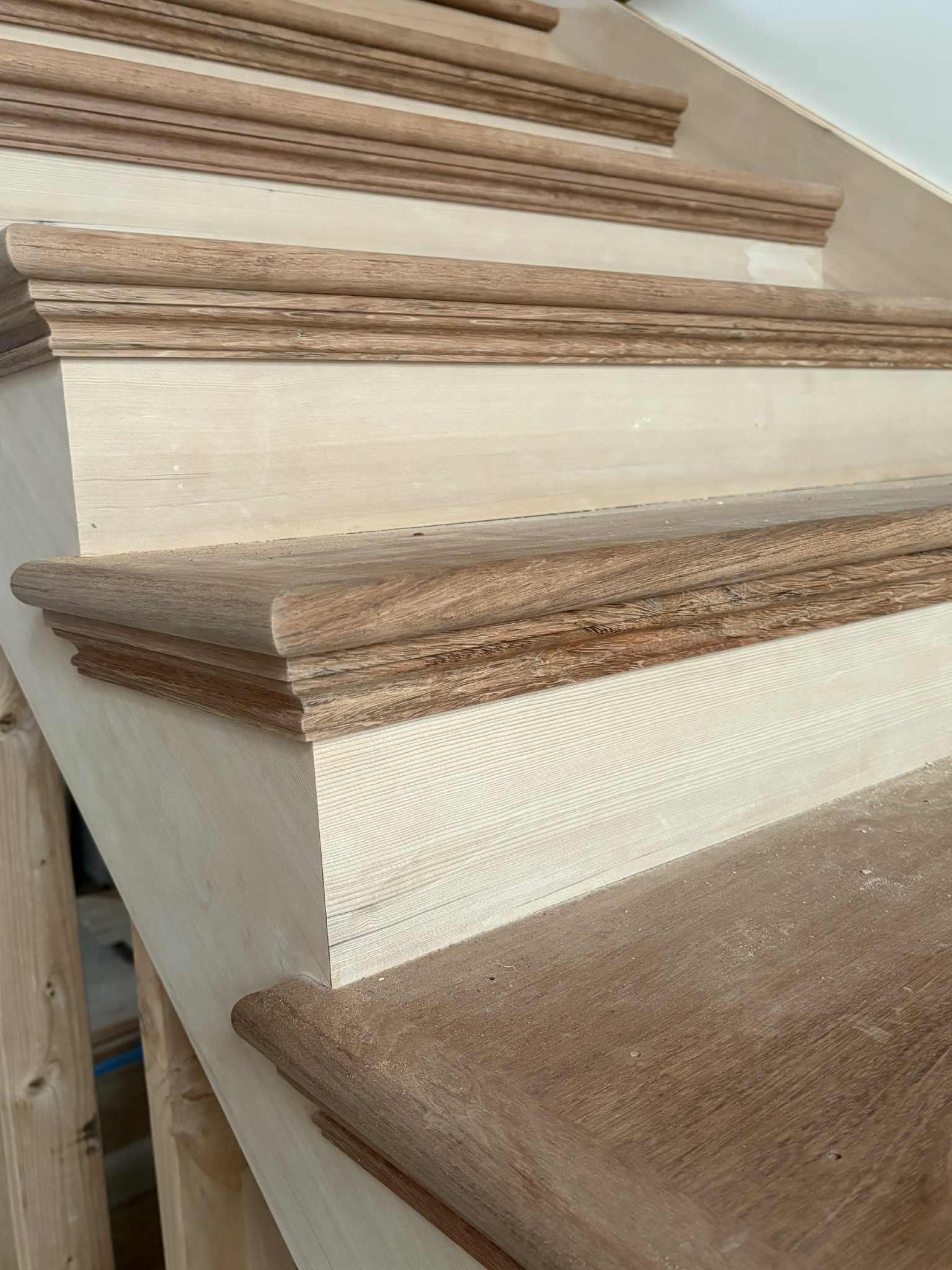 Stair tread nosing edge detail, raw pine, precision-cut profile